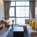 Bright modern rental living room with a panoramic window, the kind of listing an Airbnb WordPress theme showcases