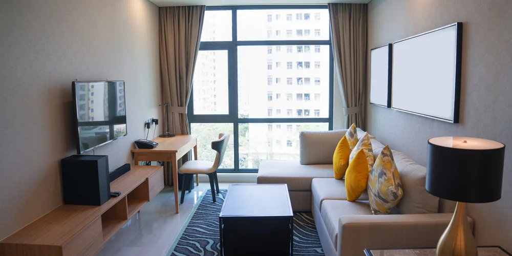 Bright modern rental living room with a panoramic window, the kind of listing an Airbnb WordPress theme showcases