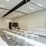 Empty conference room with presentation screens, a typical hourly booking use case in WordPress